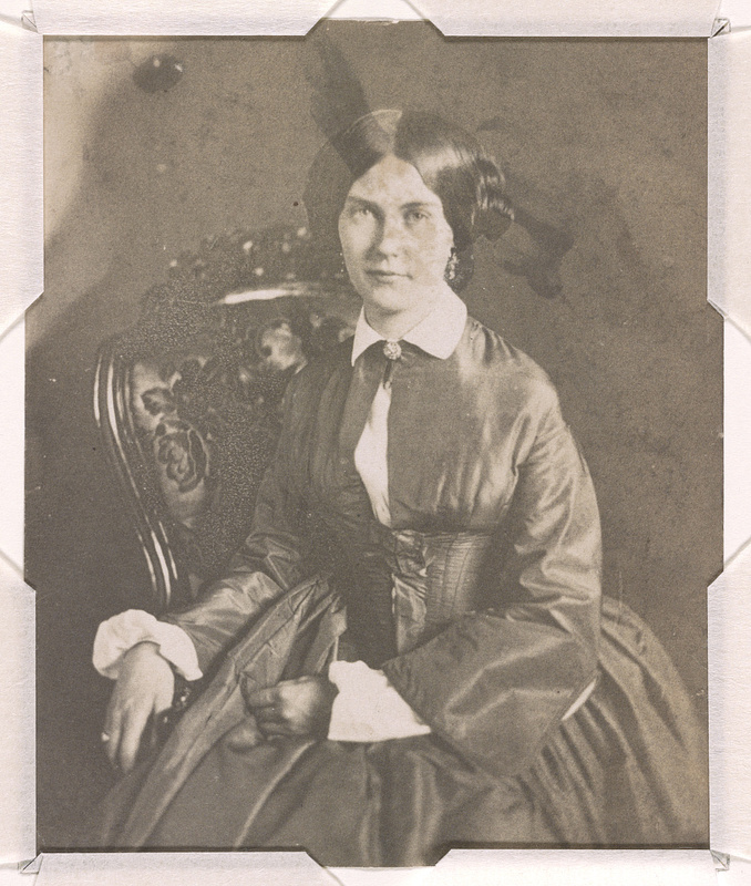 Mrs. Edwin Booth (Mary Devlin), three-quarter length studio portrait, seated with right hand resting on the arm of the chair and left hand on lap, facing front